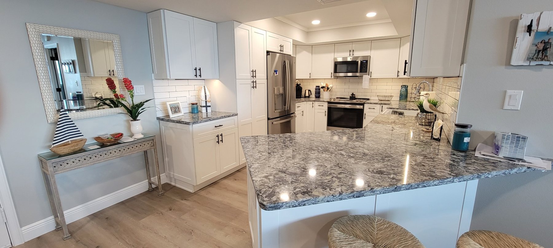Completed white kitchen with stone peninsula