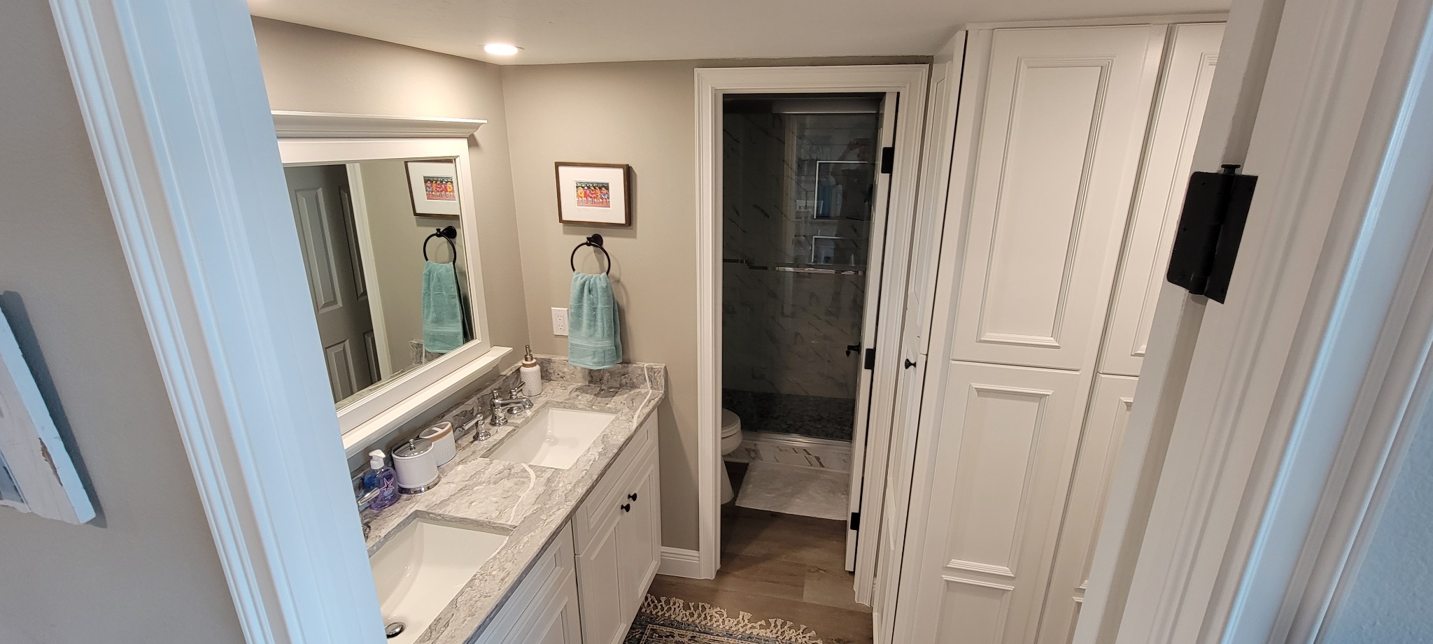 Completed bathroom with double vanity and custom storage