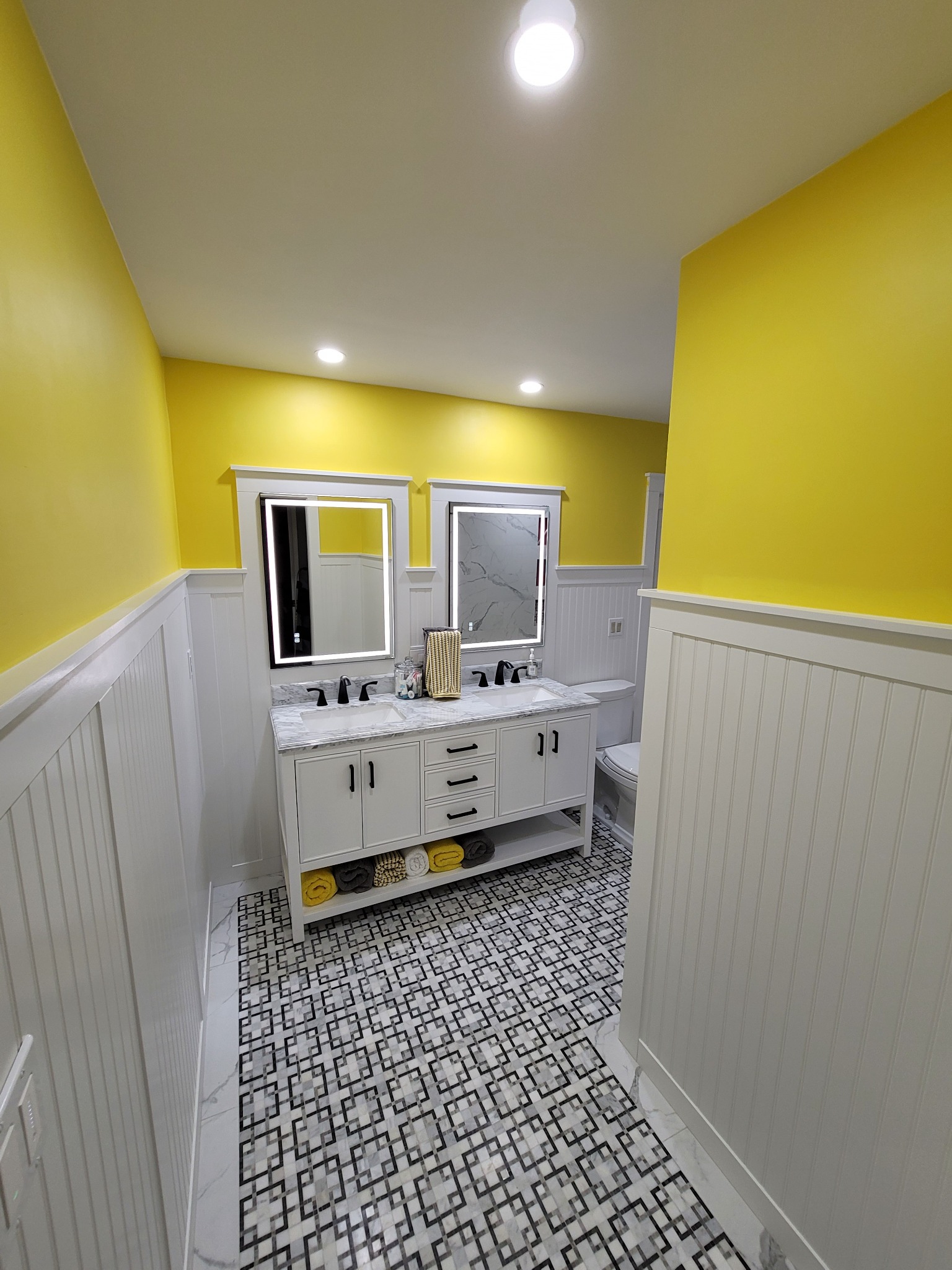 Completed bathroom vanity and geometric mosaic floor